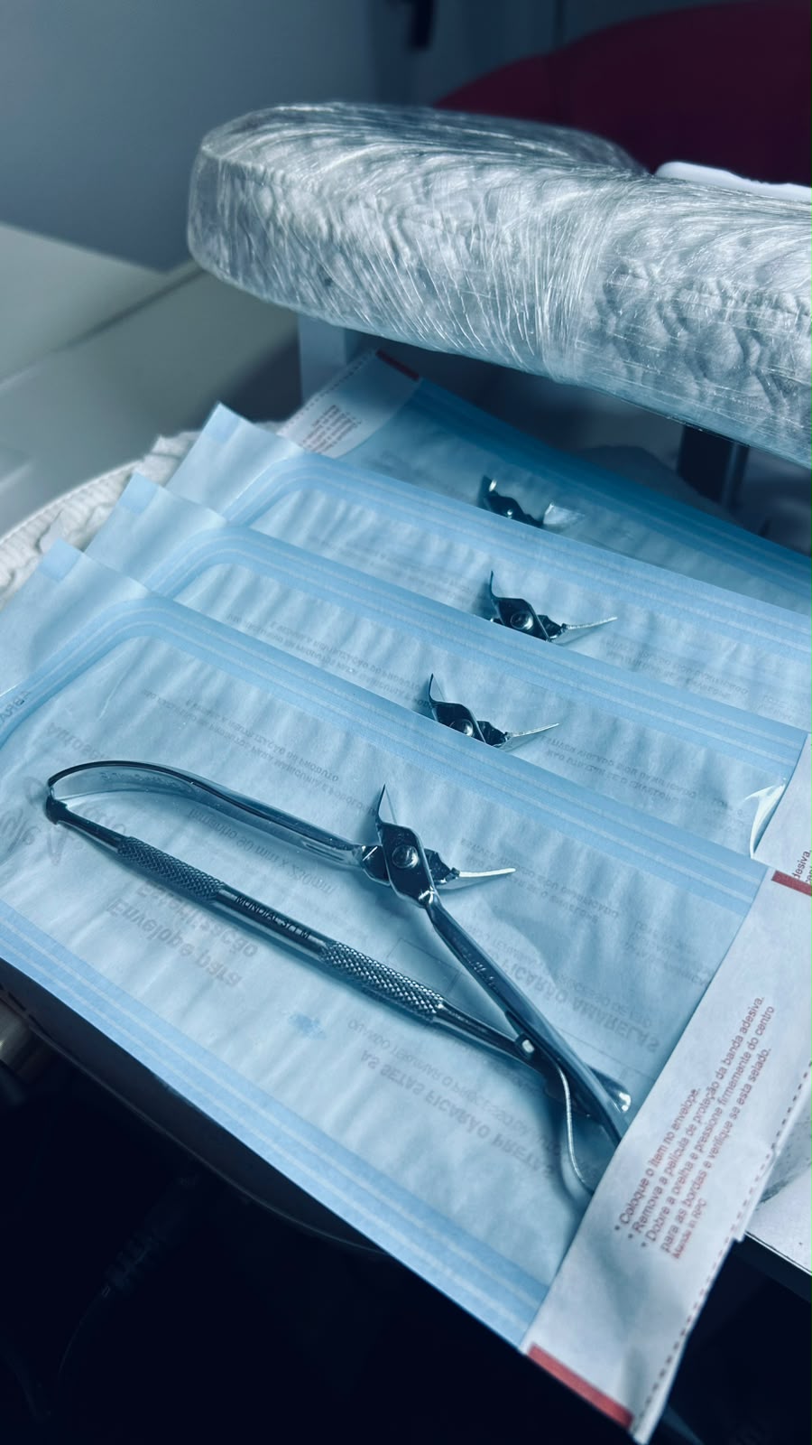 Alicates embalados individualmente em envelopes de esterilização sobre a bancada